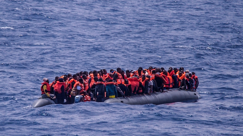 People on a rubber boat off the coast of Libya await rescue