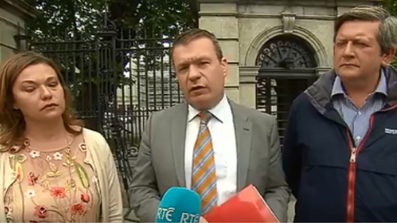 Alan Kelly (C) was joined at the launch of the bill by Mignon and Derek Underwood