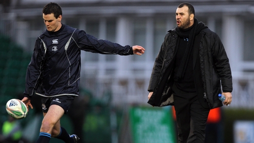 Johnny Sexton takes instructions from then Leinster head coach Michael Cheika prior to a Heineken Cup game in 2010