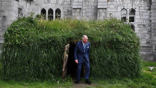Britain's Prince Charles inspects a 'Famine hut' at University College Cork