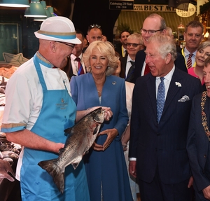 The Prince of Wales and Camilla, Duchess of Cornwall, meet fishmonger Pat O'Connell as they visit the English Market in Cork