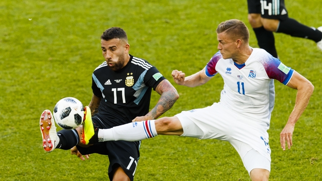 Alfred Finnbogason and Nicolas Otamendi battle for possession in Moscow