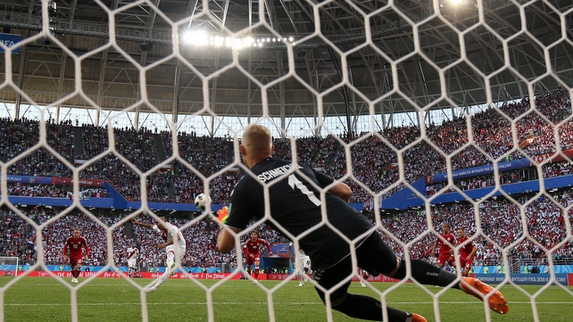 Kasper Schmeichel dives as Christian Cueva of Peru misses a penalty
