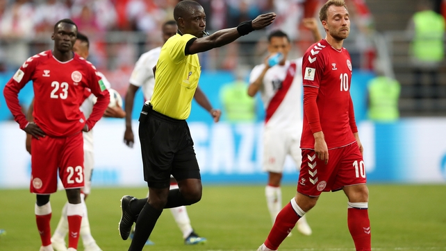 Referee Bakary Gassama awards a penalty to Peru after consulting with VAR technology