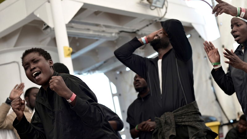 People on board the Aquarius react as the ship approaches Valencia
