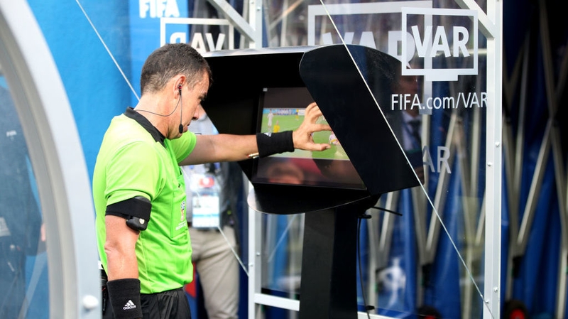 Referee Joel Aguilar reviews the VAR footage before awarding Sweden a penalty against South Korea