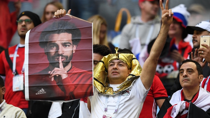 An Egypt fan holds up a poster of Mo Salah