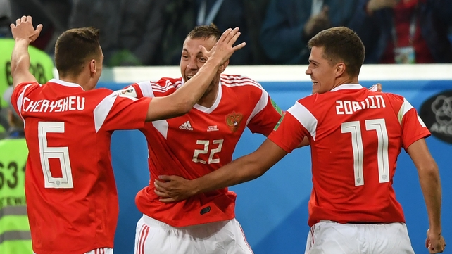 Russia's midfielder Denis Cheryshev, Russia's forward Artem Dzyuba (C) and Russia's midfielder Roman Zobnin celebrate