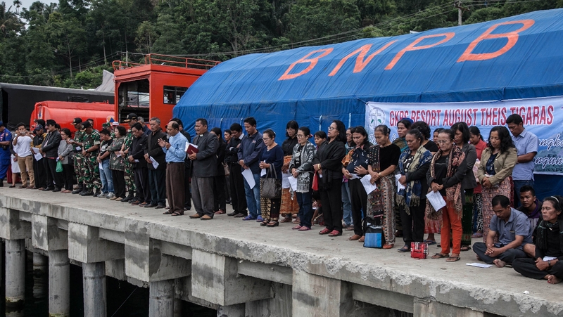 Desperate relatives awaiting news of loved ones prayed and sang hymns at the port on Lake Toba