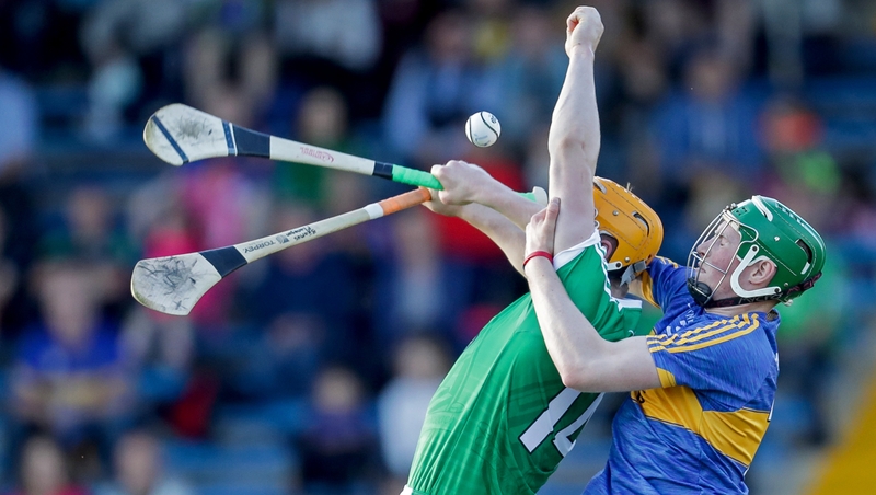 Limerick's Seamus Flanagan and Brian McGrath of Tipperary compete for the ball