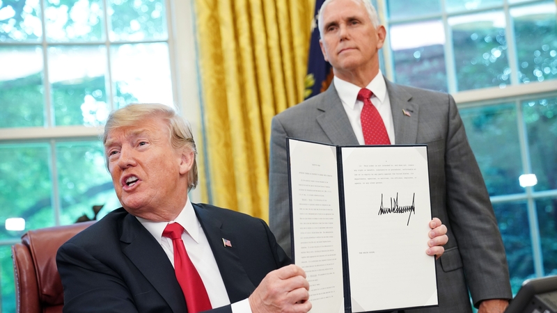 Donald Trump signs his latest executive order at the White House