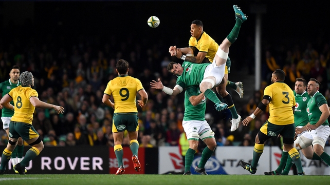 Israel Folau and Peter O'Mahony contest the first kick of the game
