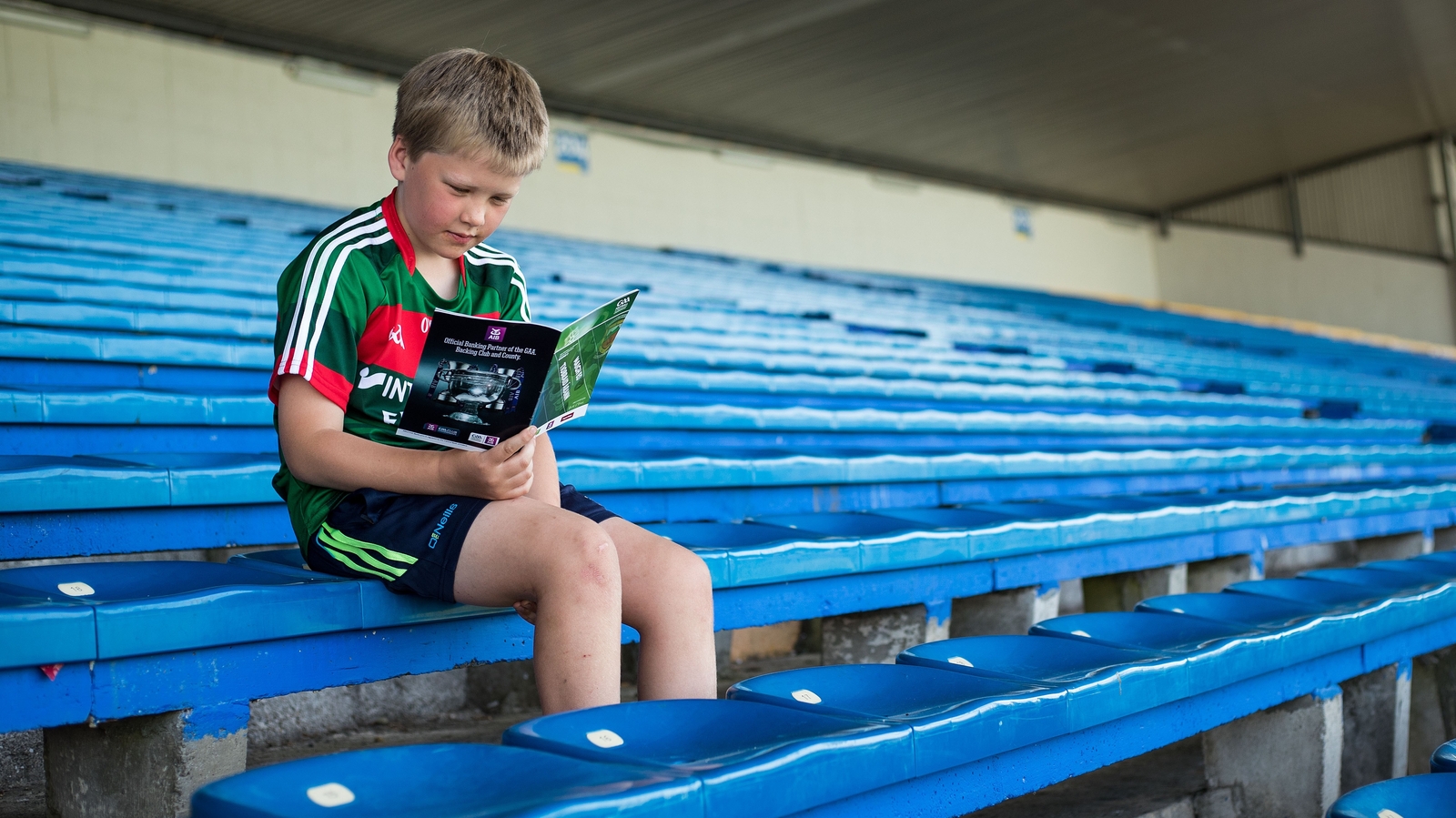 A young fan reads the programme, but is it becoming a pointless endeavour?