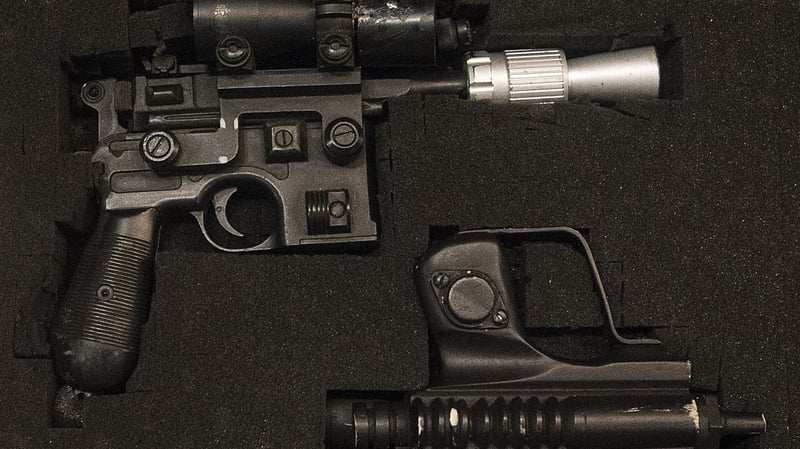 Han Solo's BlasTech DL-44 blaster and a Star Wars biker scout blaster