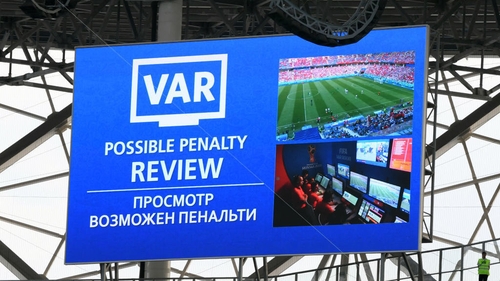 The big screen inside the stadium displays a VAR penalty review during the game between Saudia Arabia and Egypt