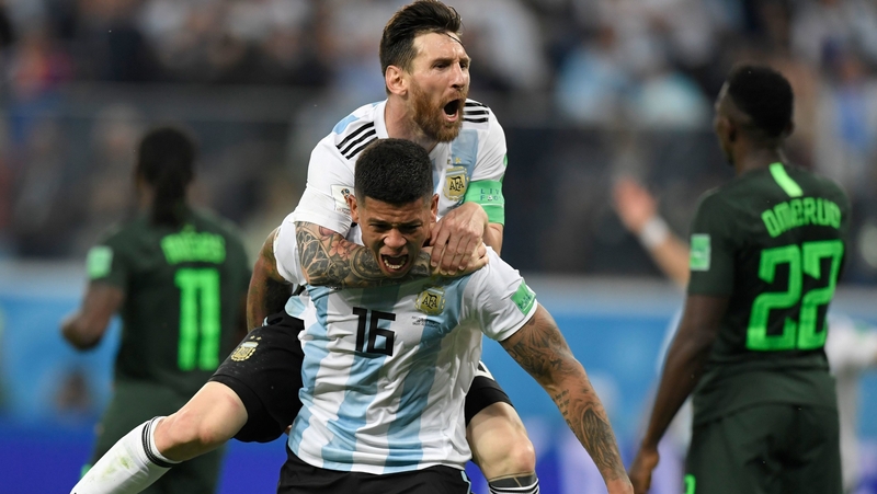 Lionel Messi celebrates with goalscorer Marcos Rojo as Argentina went through