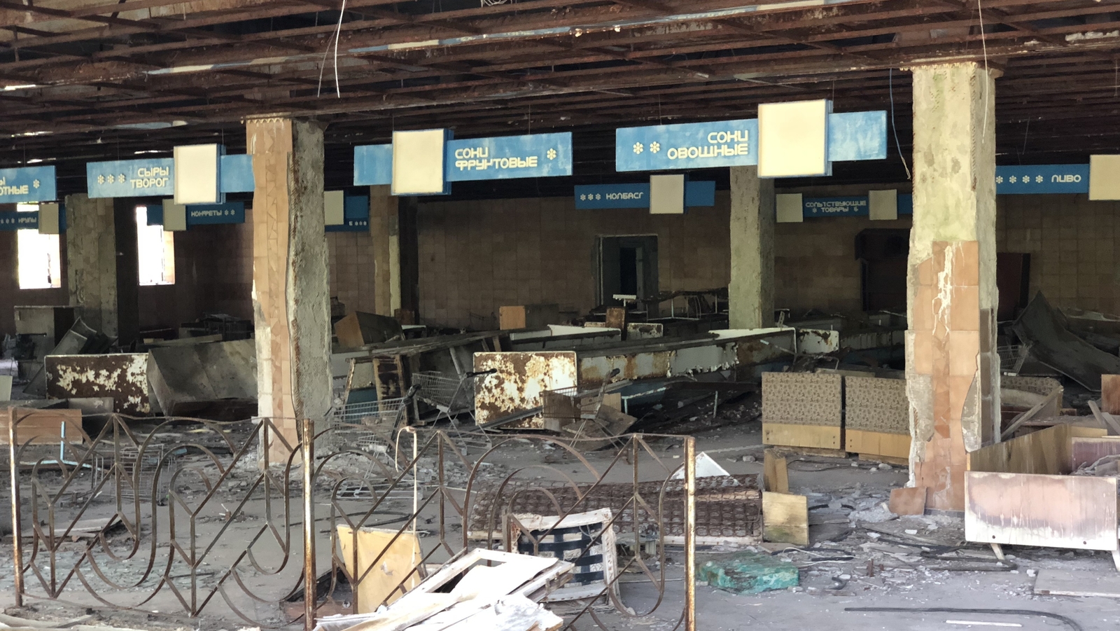 The checkouts, shelves and trolleys still visible in the abandoned supermarket of Pripyat