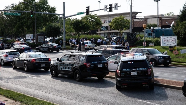 Police take measures after multiple people were fatally shot and wounded when a gunman opened fire at the Capital Gazette newsroom