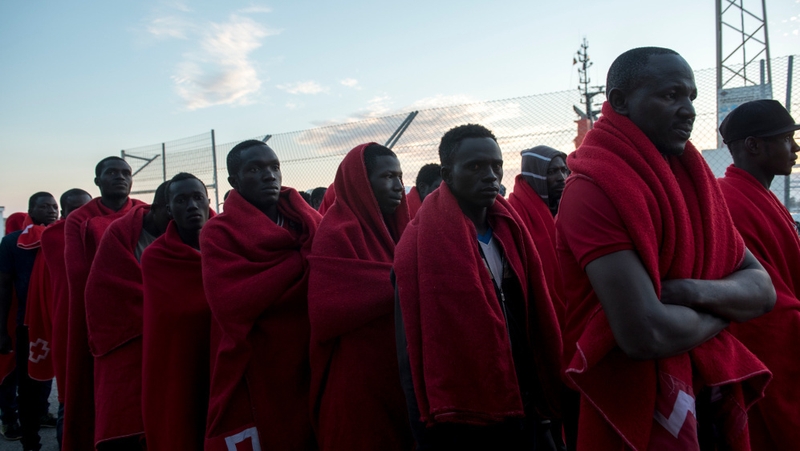 Migrants wait to be registered and assisted by Red Cross at Motril port, Granada, Spain
