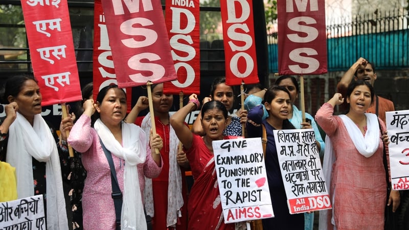 Activists hold placards as they protest against the rape in Mandsaur, India