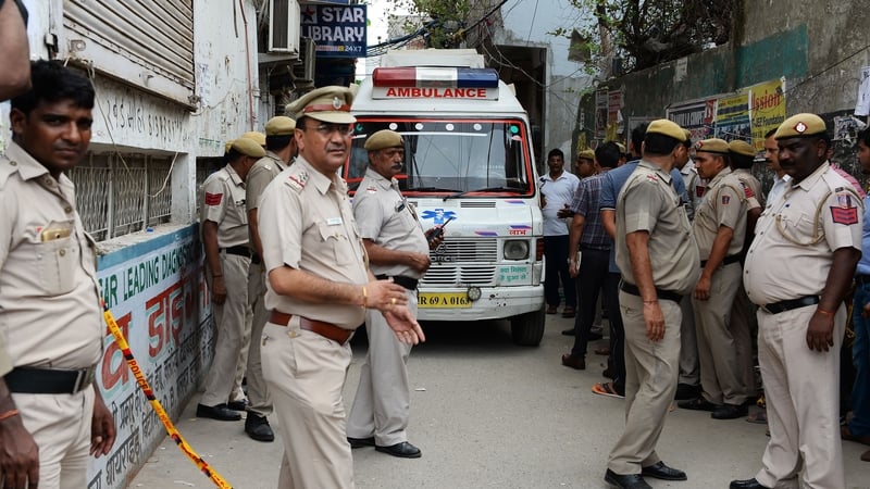 Police and an ambulance attend the scene at the house in New Delhi