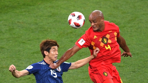 Vincent Kompany of Belgium wins a header from Yuya Osako of Japan
