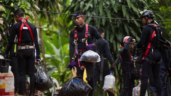 Rescuers are examining how to get the boys out through several kilometres of flooded tunnels
