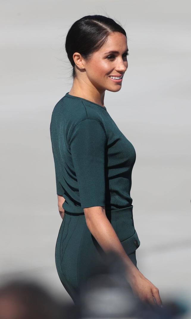 The Duchess of Sussex is wearing an emerald green Givenchy dress