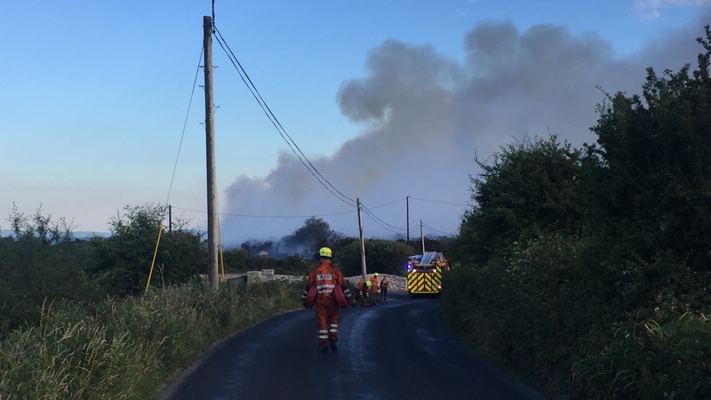 Fire crews have been dousing adjoining land in an effort to contain the fire