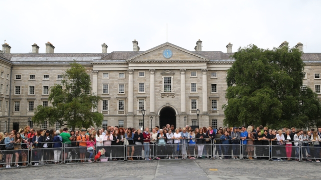 Crowds outside Trinity College Dublin await the arrival of the Duke and Duchess of Sussex