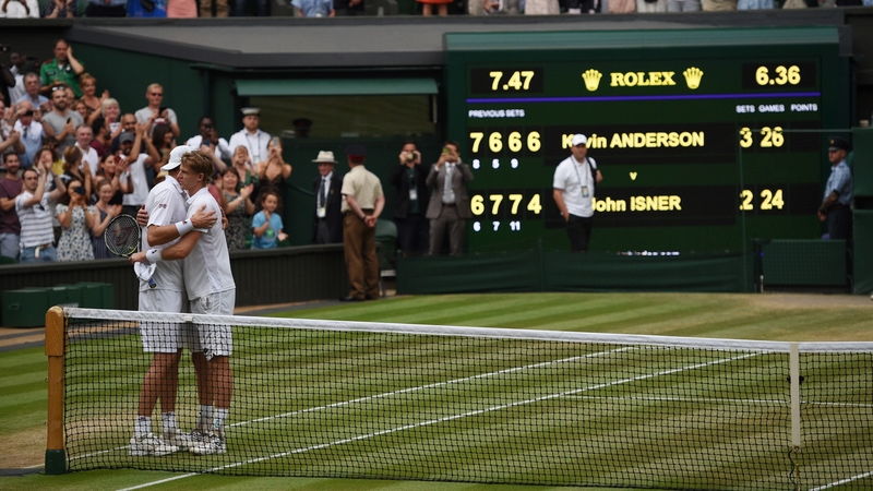 Kevin Anderson and John Isner embrace a the net