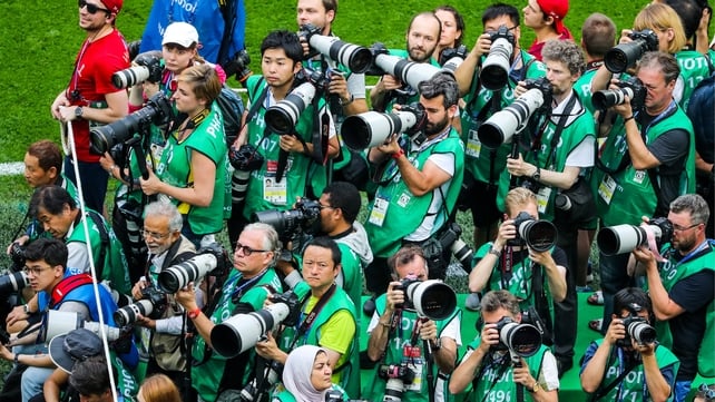 Photographers vie for the best position as the teams emerge