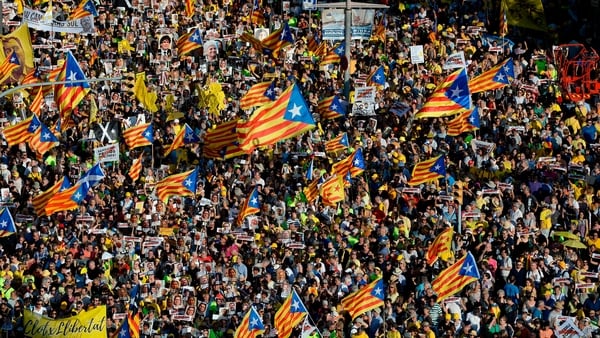 Waving yellow, red and blue Catalan separatist flags, they held banners that read "Freedom for political prisoners" or "we want you back home"