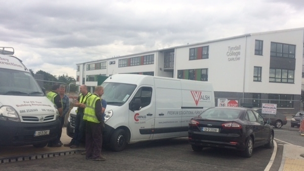 Men removed large railings from the perimeter wall of Tyndall College's new school building