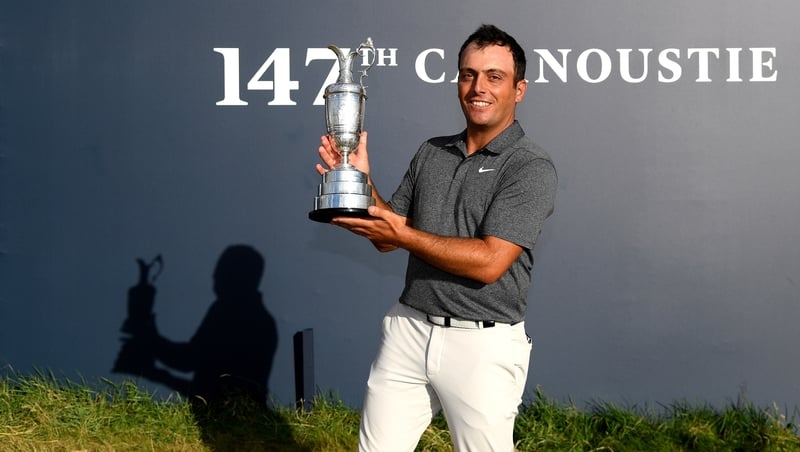 Francesco Molinari hoists the famous Claret Jug following his Open success