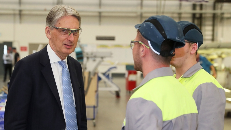British Chancellor Phillip Hammond meets apprentices during a visit to the Bombardier factory in Belfast