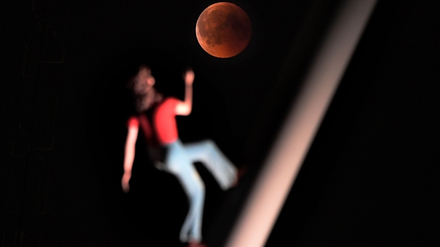 Eclipse is pictured with a sculpture by artist Jonathan Borofsky 'Woman walking to the sky' in Strasbourg