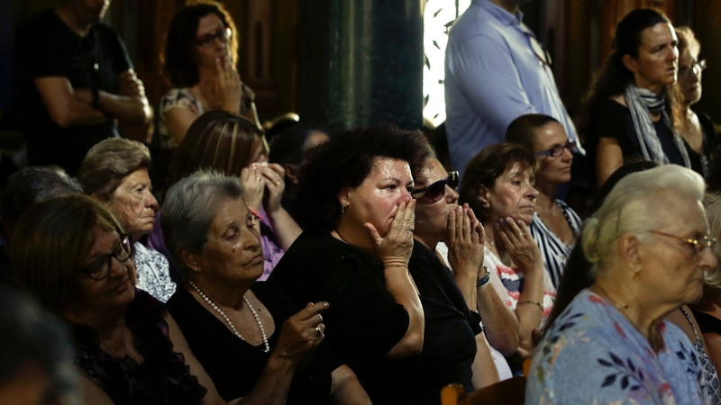 Mourners at a church service in Mati