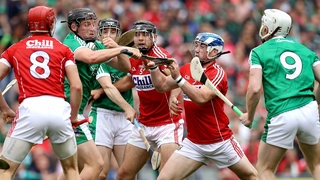 Cork and Limerick players scrap for possession