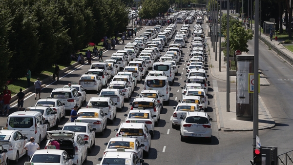Taxi drivers with their vehicles block the Paseo de la Castellana Avenue in Madrid