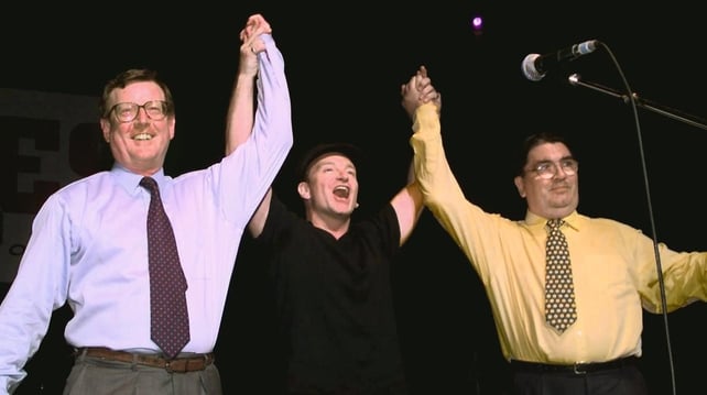 Bono holds up the hands of David Trimble and John Hume during a concert in Belfast during the 1998 peace referendum