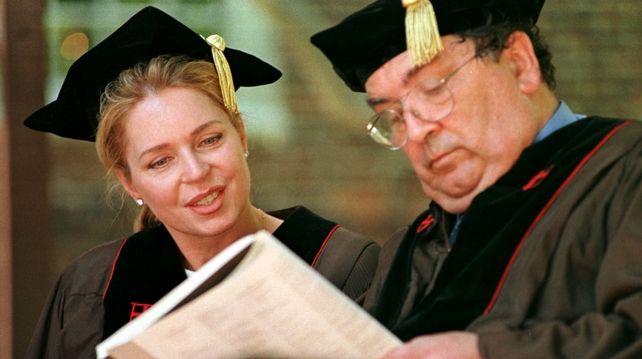Queen Noor of Jordan checks the programme with Mr Hume at a ceremony in the US in 1999