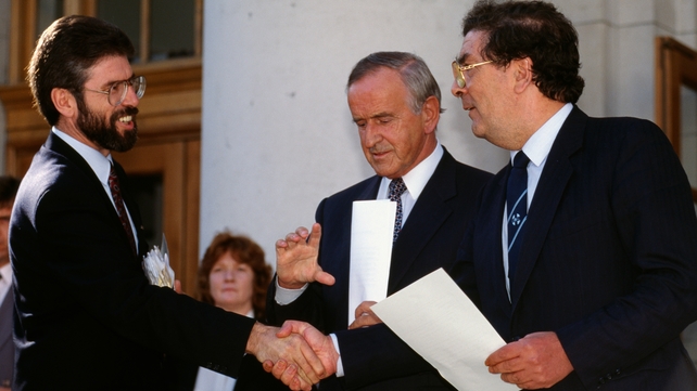 Gerry Adams and John Hume shake hands as Albert Reynolds looks on