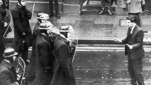 Seen stepping into the path of riot police who move in to break up a demonstration in Derry in 1969