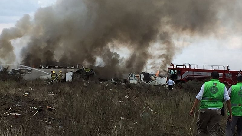 Emergency personnel at the site of the Aeromexico plane crash