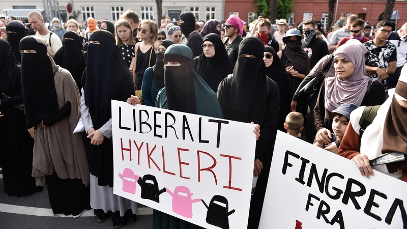 Face covered women protest in Copenhagen on the first day of the implementation of the Danish face veil ban