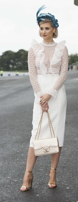 Katie Geoghegan looked every bit the lady in a white dress and beautiful blue headpiece. Check out that Chanel purse!