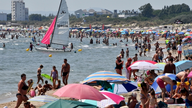 People enjoy the hot weather beach in La Grande-Motte, France