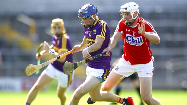 Wexford's Rory Higgins with Cork's Eoghan Murphy
