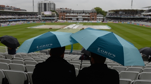 Spectators under umbrellas at Lord's